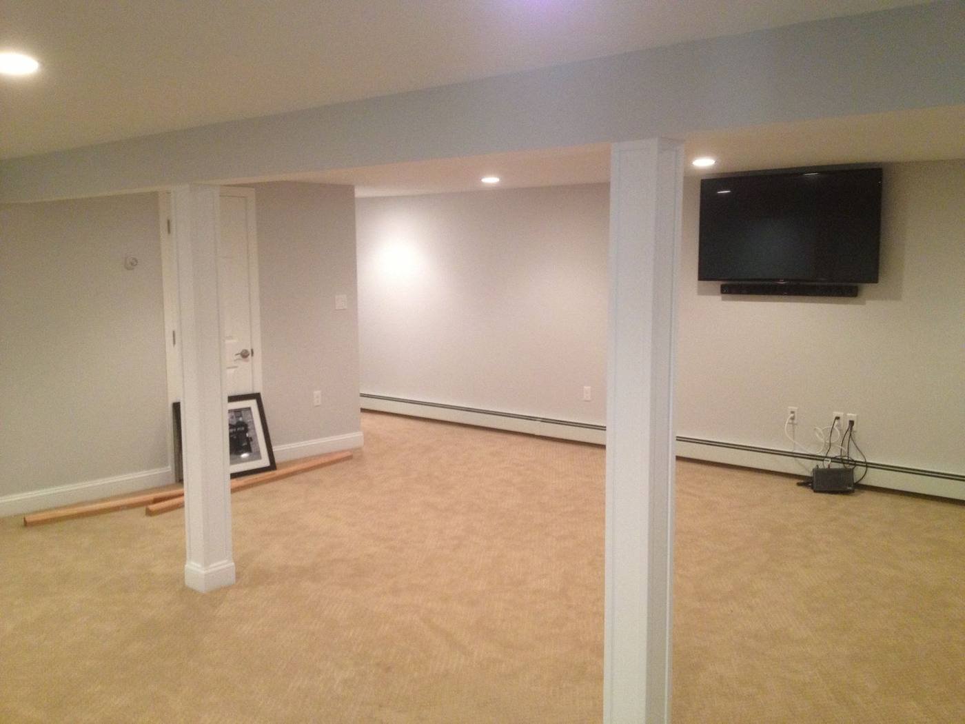 Open finished basement with wall-mounted TV