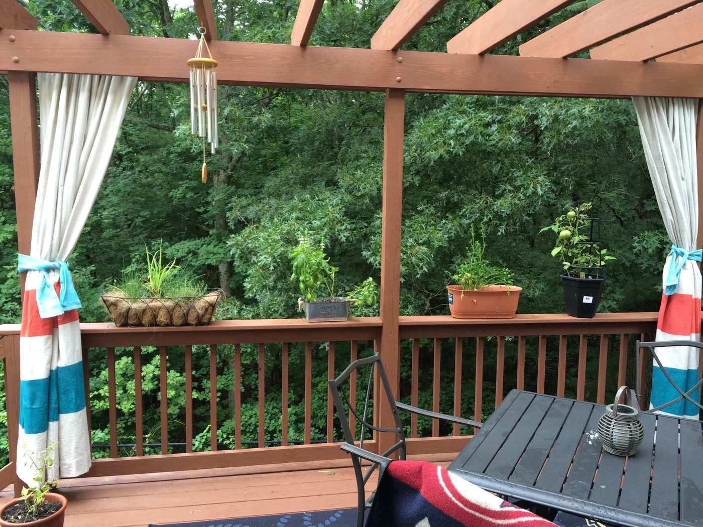 Deck with a cedar pergola and curtains