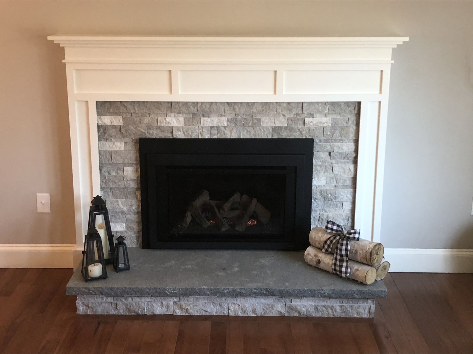 Stone fireplace with white mantle