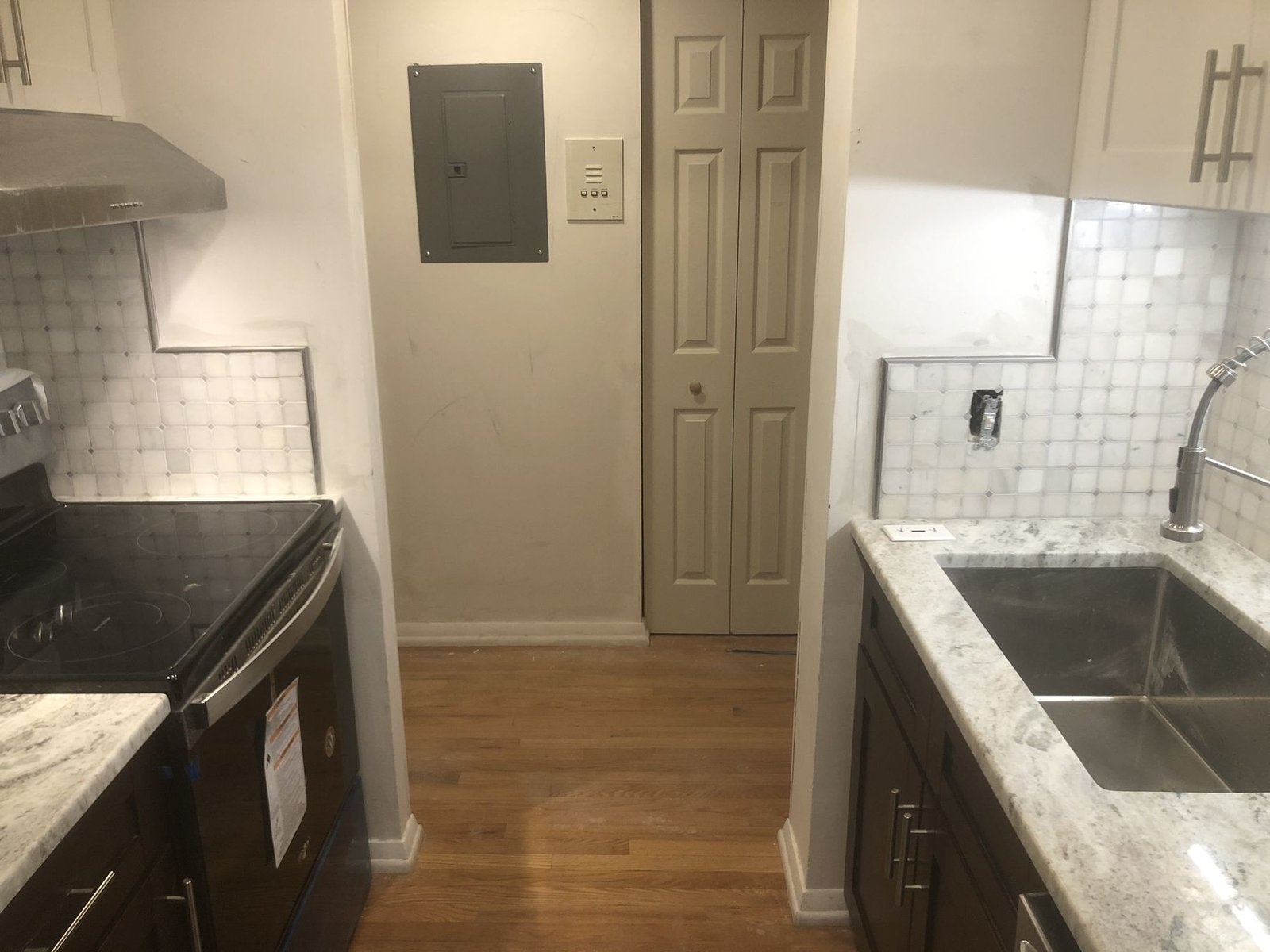 Kitchen with marble counters and tile backsplash