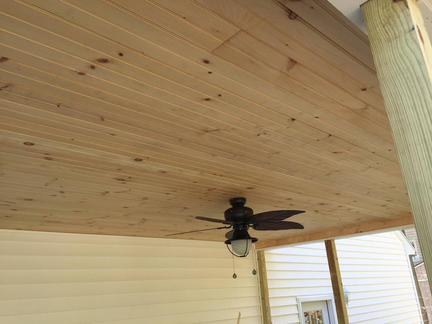 Tongue and groove porch ceiling with a ceiling fan