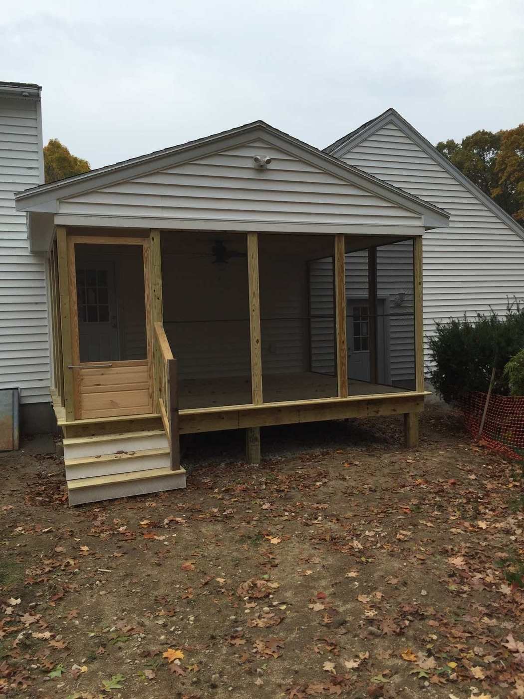 Screened porch and breezeway from the front with steps