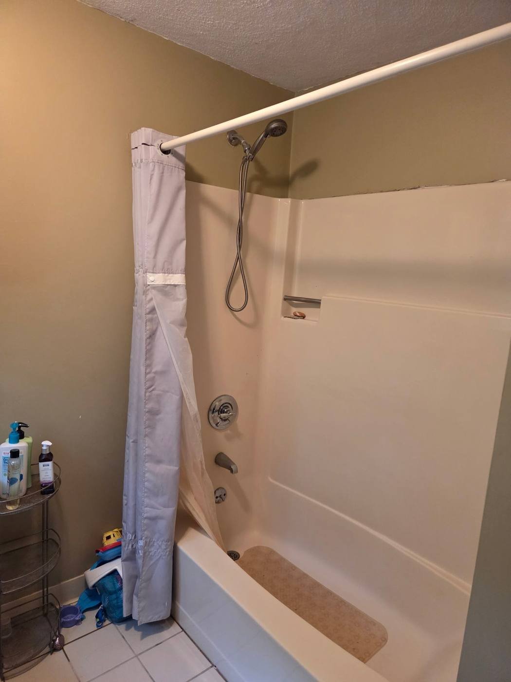 Original fiberglass tub and shower unit before remodel